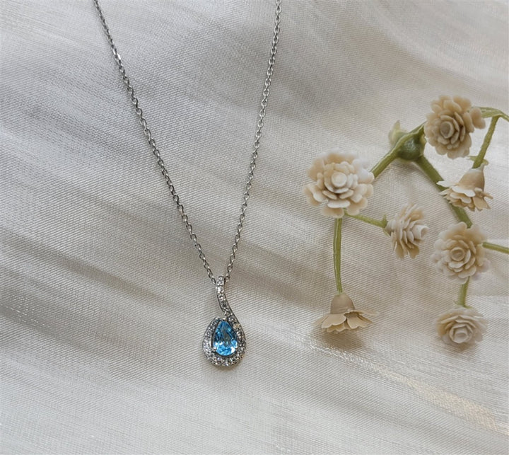 10K White Gold Blue Topaz & Diamond Halo Pendant